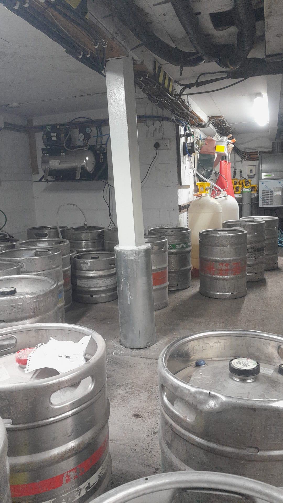 Pub cellar galvanised pipe support after remedial works